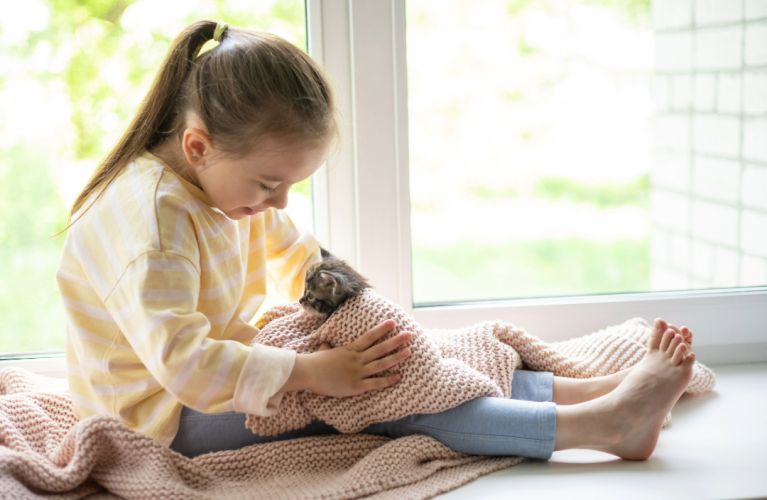 Girl holding a Baby Maine Coon kitten